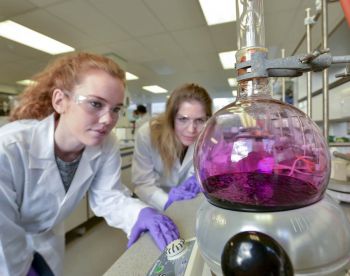Two students conducting a chemistry experiment in the lab