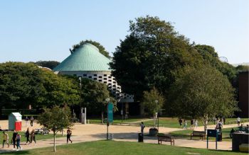 students crossing library square on a sunny day