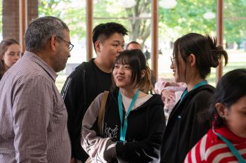 International scholarship recipients speaking with Professor Robin Banerjee