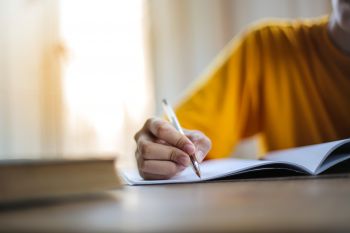 A person studying and writing notes