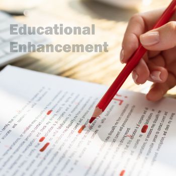 A close-up of a red pencil marking an assignment. The watermark of Educational Enhancement overlays the image.