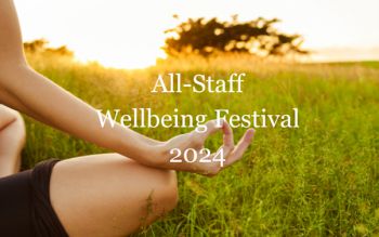 Picture of a person in a field with the words wellbeing festival spelled out