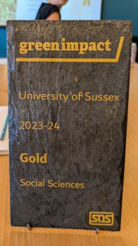 A sign stating that the Social Sciences team have won the GOLD Green Impact award