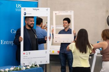 A student posing with a selfie frame