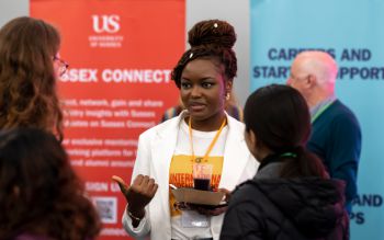 Alumni talking to students at a careers event