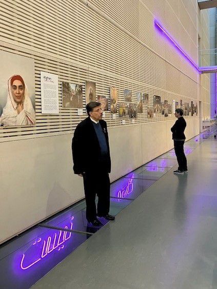 People viewing the photographs in the collection