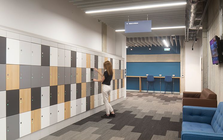 A woman opening a locker