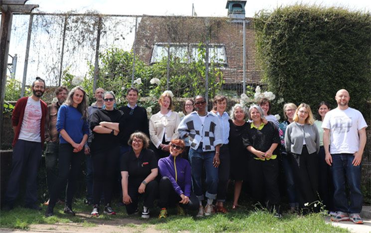 group of people outside in a garden
