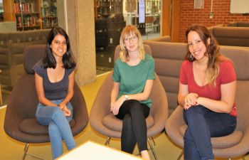 Three female Research Hive Scholars sitting down in a row