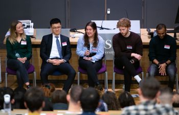 A photo of five panellists at Make it Happen 2020, sitting at the front of a lecture hall speaking to students