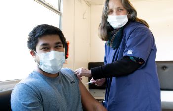 Student getting his Covid-19 vaccine shot