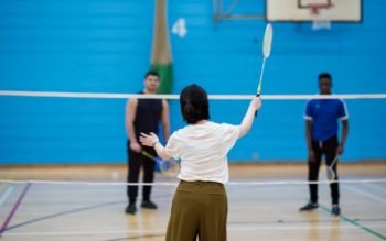 Students playing badminton in the sports centre