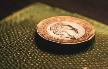 Two pound coins on a blue background