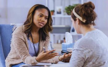 Therapist speaking to a student