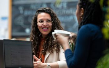 Two students talking over a cup of coffee