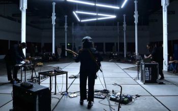 Photo of the music show in front of an audience taken from behind the musicians