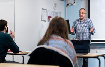 A teacher presents to the class