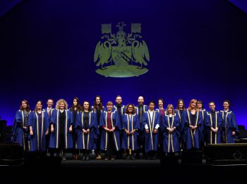 PS staff dressed with gowns at the graduation ceremony