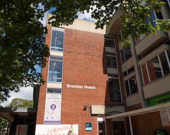 brick building with a white sign reading 'Bramber House'