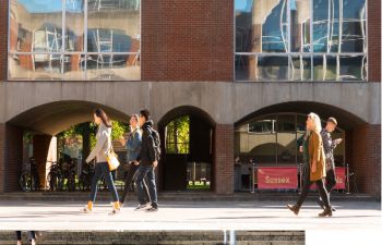 Students walking through Falmer House quad