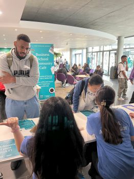 A male student talking to student ambassadors