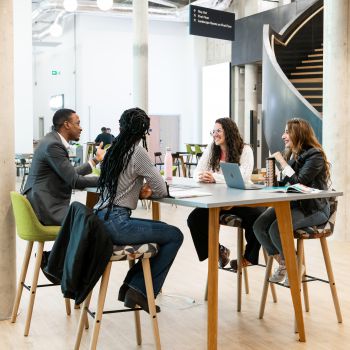 Four students sitting at a table