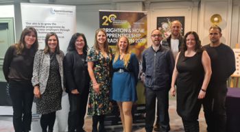 A photo of University of Sussex apprentice graduates (front row, L-R); Charlotte Littlejones, Eleanor Cartwright, Joanna Dale, Francesca Marks-Dennis, Gemma Harman, Terry Cooper, Kelly Feldman. (Back row) Aaron Munnery and Ben Ospalak