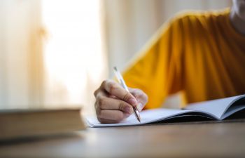 A person studying and writing notes