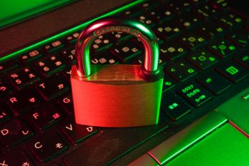 Padlock sitting on a laptop keypad