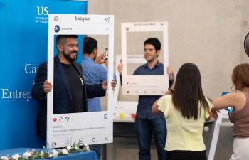 students posing with selfie frames