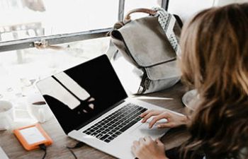 Photograph of girl using laptop