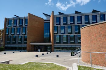 The front of Jubilee building on a sunny day with blue sky and grass in the foreground