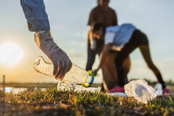 People picking up plastic rubbish from a beach