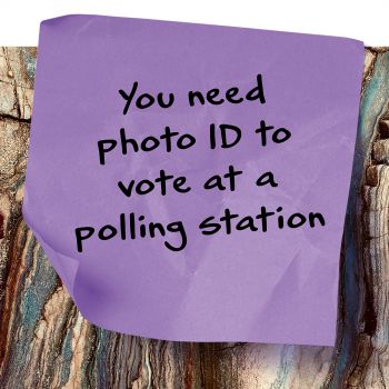 Post-it note that says you need photo ID to vote at a polling station