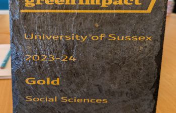 A sign stating that the Social Sciences team have won the GOLD Green Impact award