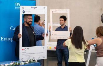 A student posing with a selfie frame