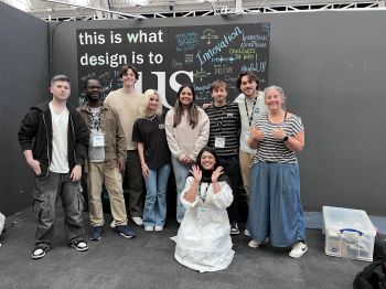 Dr Claire Potter [far right] and eight students who presented at New Designers this year in front of a poster that reads 