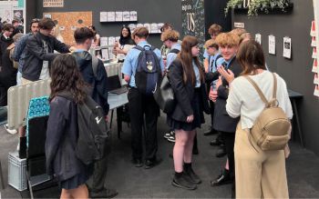 Teenagers wearing school uniforms visiting the Sussex stand