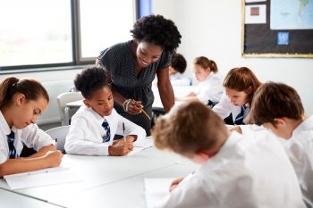 School students and their teacher in a classroom in the UK