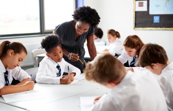 School students and their teacher in a classroom in the UK