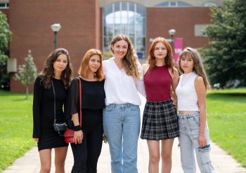 Alina, Yuliia, Professor Honsalies-Munis, Ivanna, and Yelizaveta outside Falmer House on the University of Sussex campus