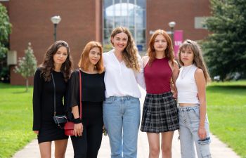 Alina, Yuliia, Professor Honsalies-Munis, Ivanna, and Yelizaveta outside Falmer House on the University of Sussex campus