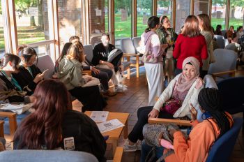 A photo of some students socialising inside the Meeting House during Welcome Week