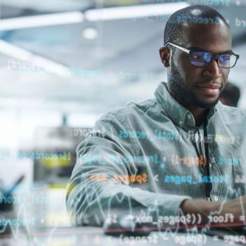 A man sitting at a desk coding