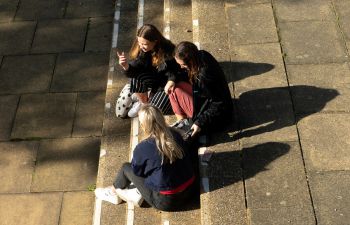 A group of students sit on steps