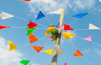 Bunting flying in a blue sky