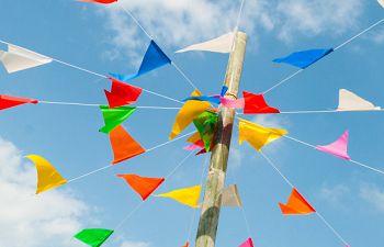 Bunting flying in a blue sky