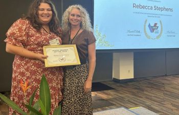 Rebecca Stephens (right) receives her 'Member of the Year' award from the President of the IAVSW