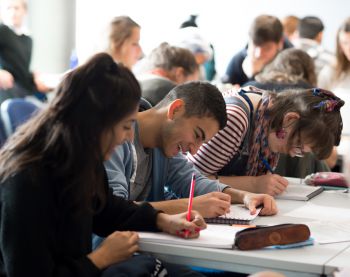 Students write notes in a seminar