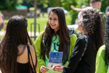 An Ambassador talks to visitors at an Open Day